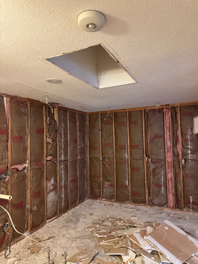 Interior room with wall coverings removed and framing exposed