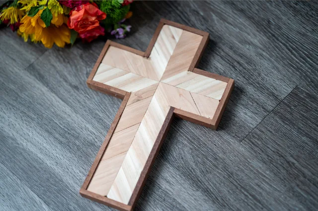 Handmade wooden cross with a contrasting geometric wood pattern